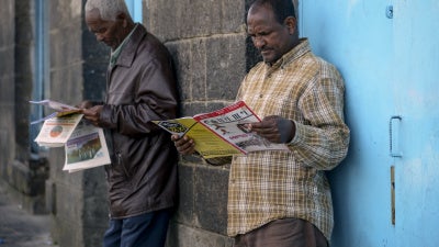 People read newspapers and magazines on a street in Addis Ababa, Ethiopia, November 7, 2020.