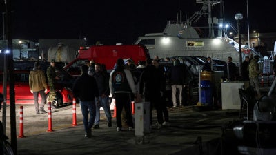 Greek emergency personnel wait to transfer bodies of dead migrants, following migrant's boat collision with coast guard off the island of Chios, in the port of Chios, Greece, February 3, 2026. 