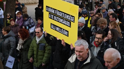 Participants hold a placard reading "The independence of the judges is your security - Stand by them!" as Hungarian judges and court employees demonstrate in Budapest, Hungary, on February 22, 2025, for independence of the judiciary, rule of law, and freedom of expression of judges.
