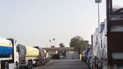 Trucks carrying humanitarian aid wait in Egypt at the Rafah crossing to enter Gaza on January 27, 2026. 