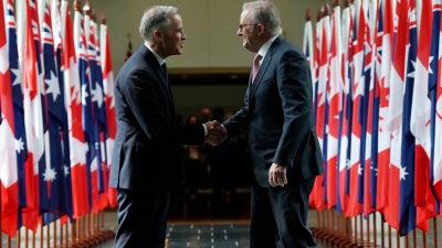 Canada's Prime Minister Mark Carney (left) and Australian Prime Minister Anthony Albanese as they leave Parliament following an address, in Canberra, Australia, March 5, 2026.