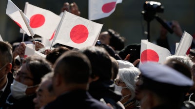 People wave Japanese flag in Tokyo, January 27, 2026.