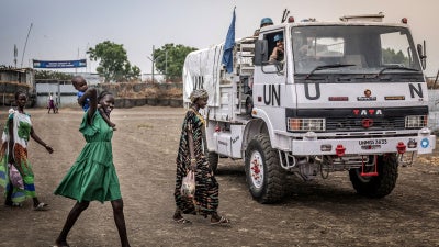 Residents react as they walk past a patrol truck operated by Indian peacekeepers serving with the United Nations Mission in South Sudan (UNMISS) in the strategic town of Akobo, Jonglei State, on February 12, 2026.