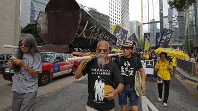Koo Sze-yiu carries a coffin that reads, “The people’s heroes, they shall remain forever immortal" at a protest in Hong Kong, May 26, 2019