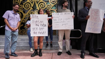 Protestors holding anti-ICE signs