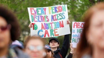 A supporter of Planned Parenthood holds a placard at a rally