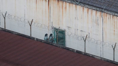 People walk inside an immigration detention center in Kuala Lumpur, Malaysia, February 23, 2023.
