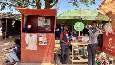 Maureen Kamatu, 28, has been self-employed at a mobile money cash-transfer booth in Lilongwe, Malawi. 