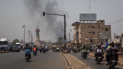 A column of black smoke rises above buildings in Bamako on April 26, 2026.