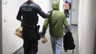 A German police officer takes a man to a deportation flight to Pakistan, February 25, 2025, Hesse, Germany.