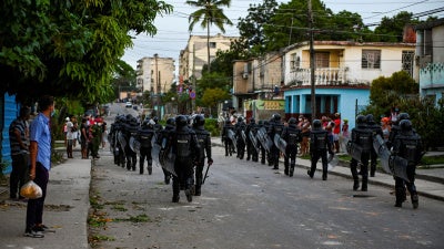 Riot police walk the streets after a demonstration against the government of President Miguel Diaz-Canel in Arroyo Naranjo Municipality, Havana, Cuba, on July 12, 2021.