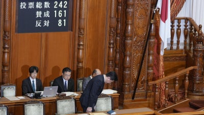 Japan's chief cabinet secretary, Minoru Kihara, bows to members of the House of Councilors after lawmakers passed a law prohibiting desecration of the national flag, Tokyo, July 17, 2026.