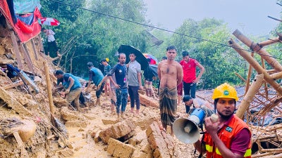 Rescuers work at the site of a landslide at a Rohingya refugee camp in Cox's Bazar, Bangladesh,  July 8, 2026.
