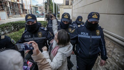 Police removing journalists from Toplum TV on March 6, 2024 in Baku, Azerbaijan.