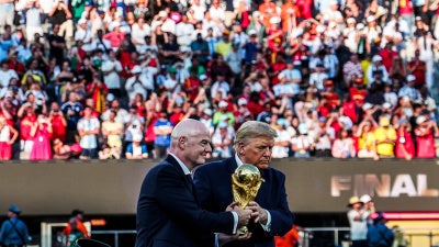Infantino and Trump jointly holding the World Cup Trophy