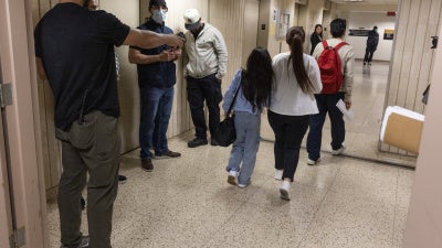 Plainclothes Immigration and Customs Enforcement (ICE) officers detain an immigrant leaving their scheduled court appearance at a Federal immigration court in New York City, June 4, 2025.