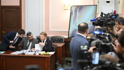 Lawyer Vitaly Iskakov (left), attorney Gadzhi Aliyev (center) and Chairman of the Yabloko political party, Nikolai Rybakov, attend a hearing on a lawsuit filed by the Rodina (Motherland) party seeking to bar the Yabloko party from the State Duma election, at the Russian Supreme Court in Moscow, Russia, August 10, 2026.