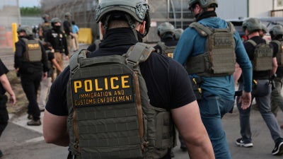 US Immigration and Customs Enforcement (ICE) agents block protesters as cars exit Delaney Hall, which is being used as an ICE detention center, on May 27, 2026 in Newark, New Jersey.