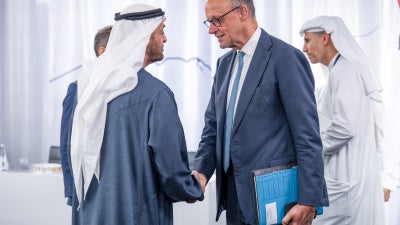 Germany's Chancellor Friedrich Merz, UAE's President Sheikh Mohamed bin Zayed al-Nahyan shake hands.