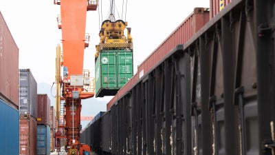 Containers are loaded onto a China-Europe Railway Express (Yiwu-Xinjiang-Europe) market procurement train at the Jinhua Yiwu Railway West Station in Jinhua, China, on June 8, 2026.