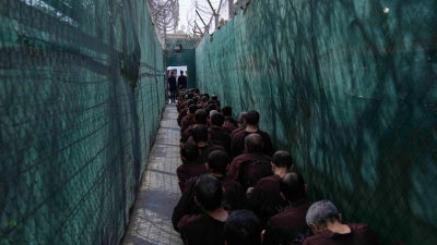 Men accused of Islamic State links await questioning at Al-Karkh prison in Iraq following their transfer from northeast Syria, February 12, 2026.