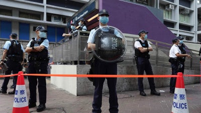 Police officers stand guard outside the Prince Edward subway station