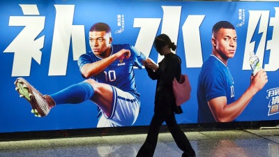 An advertisement featuring French soccer star Kylian Mbappé in Shanghai, China, June 30, 2026.