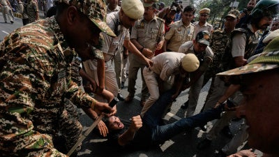 Police detain protesters during a demonstration 