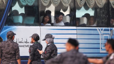 Myanmar nationals to be repatriated from Malaysia sit inside a bus, at Lumut, Malaysia, September 29, 2026.