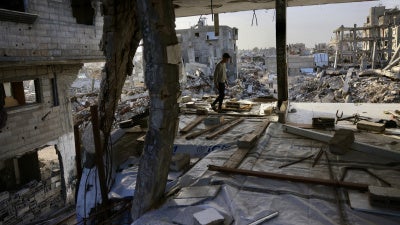 A Palestinian boy walks inside a destroyed building in Khan Yunis in the southern Gaza Strip, January 27, 2026.