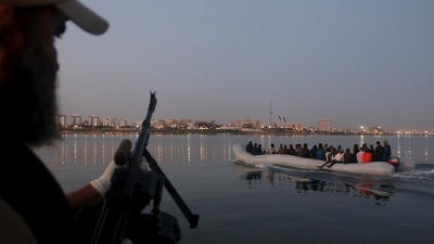Migrants on a boat that they tried to take to Italy, after being detained at a Libyan Navy base in Tripoli on September 20, 2015.