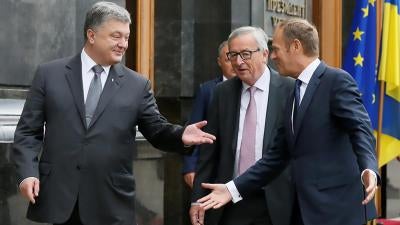 Ukrainian President Petro Poroshenko, European Commission President Jean-Claude Juncker and European Council President Donald Tusk arrive for a joint news conference following the EU-Ukraine summit in Kiev, Ukraine, July 13, 2017. 