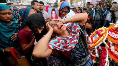 Relatives of victims killed in Rana Plaza building collapse in 2013, mourn at the site during the fourth anniversary of the collapse in Savar, on the outskirt of Dhaka, Bangladesh, April 24, 2017. REUTERS/Mohammad Ponir Hossain