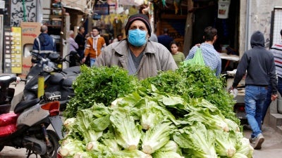 A street vendor pushes his cart in Shatila Palestinian refugee camp, wearing a face mask to try to protect against the spread of COVID-19, in Beirut suburbs, Lebanon, March 30, 2020.
