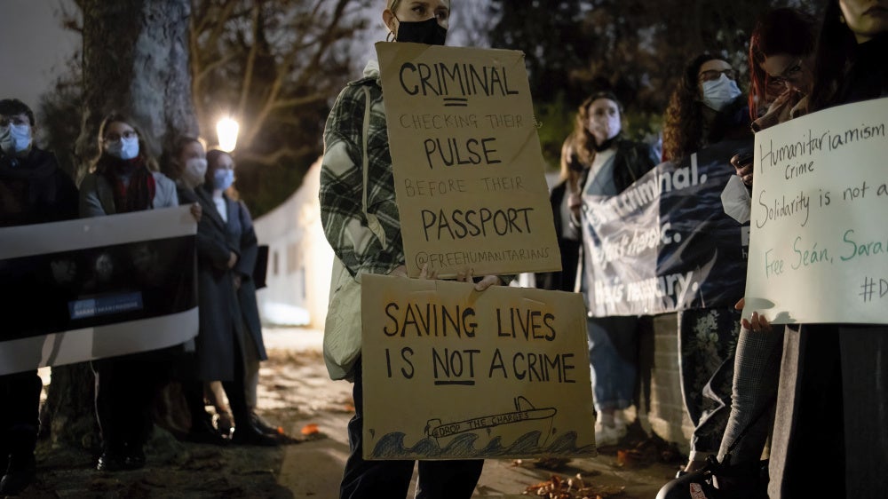 Protesters hold placards in solidarity with humanitarians who were still detained in Greece, November 18, 2021.