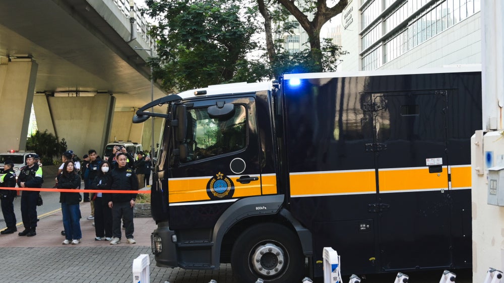 Prisoner transport vehicles outside the court in Hong Kong