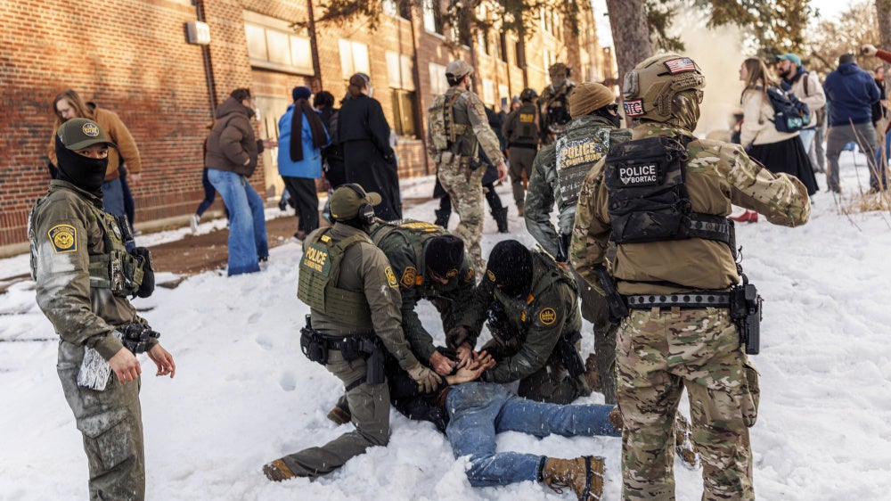 US Border Patrol agents detain a person near Roosevelt High School during dismissal time as federal immigration enforcement actions sparked protests in Minneapolis, Minnesota, on January 7, 2026. 