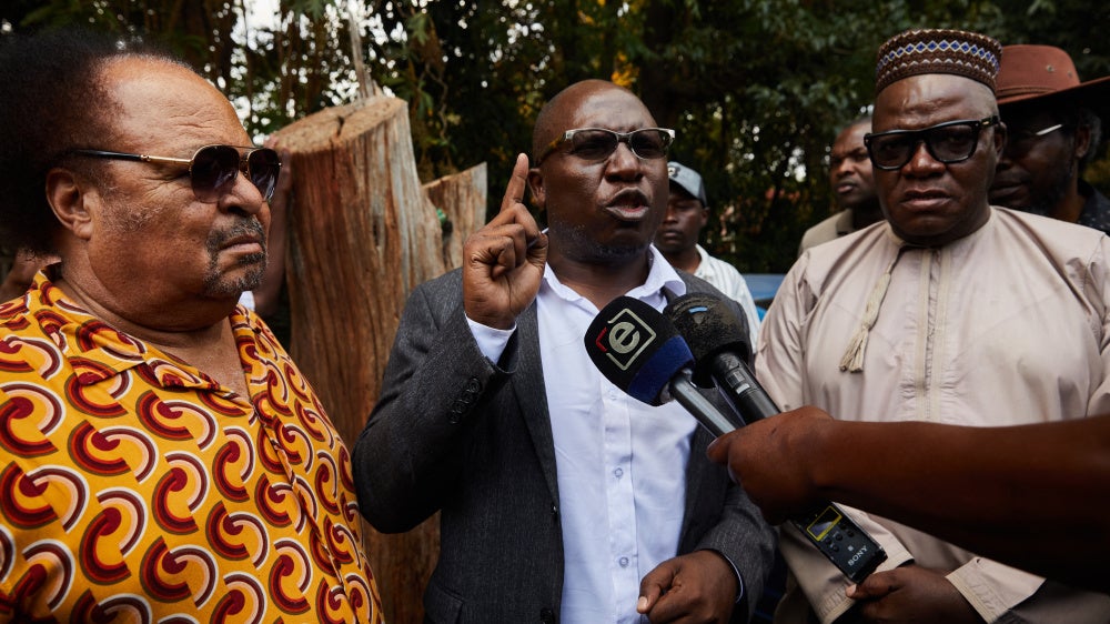SAPES Trust director Ibbo Mandaza (L) listens to Jacob Ngarivhume (C) and Tendai Biti (R) speaking to the media at the Trust in Harare, Zimbabwe on October 28, 2025.