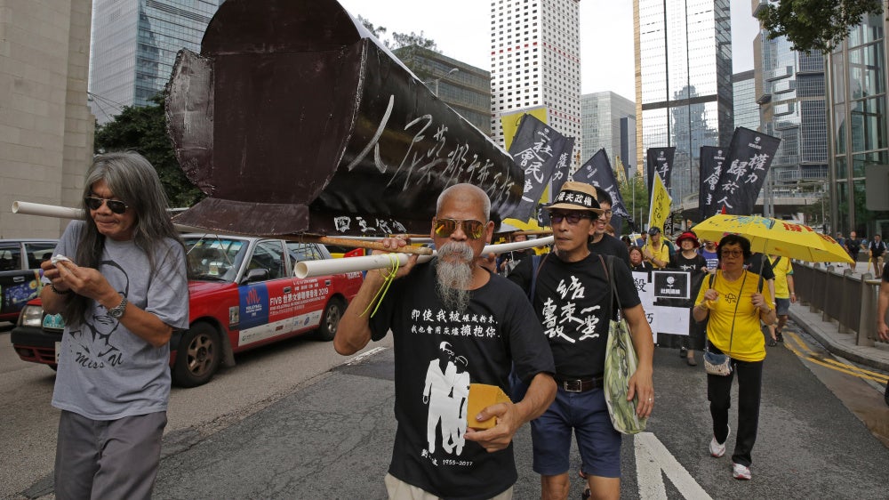Koo Sze-yiu carries a coffin that reads, “The people’s heroes, they shall remain forever immortal" at a protest in Hong Kong, May 26, 2019