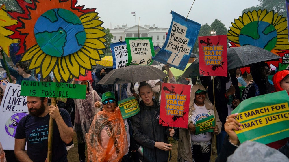Climate activists hold a rally to protest the use of fossil fuels in front of the White House