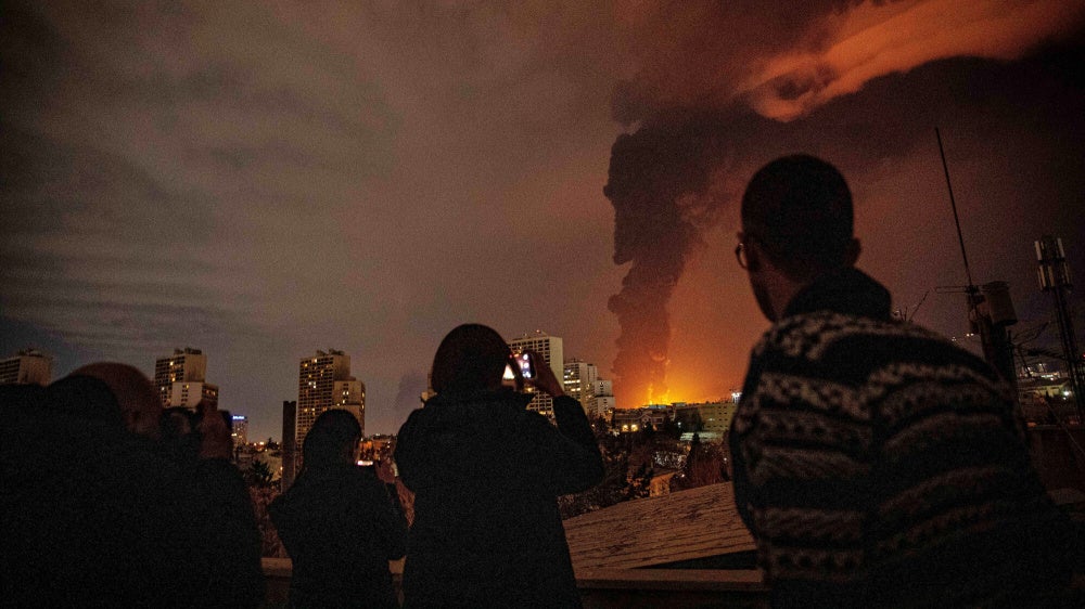 Flames and smoke rise from an oil storage facility following Israeli airstrikes in Tehran, Iran, March 7, 2026. 