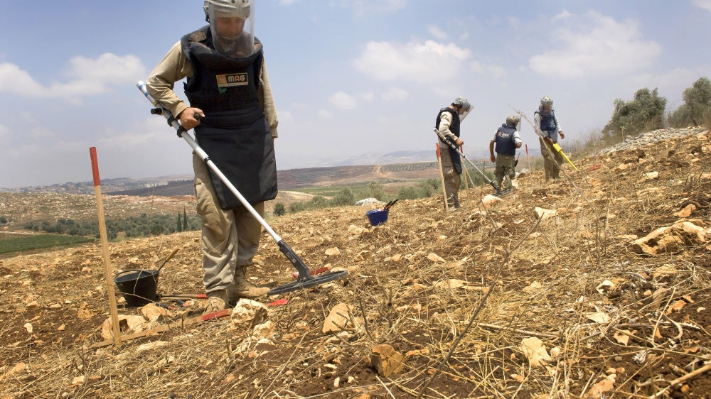 A team from the Mines Advisory Group (MAG) clearing unexploded cluster munitions on farmland in southern Lebanon, November 10, 2020. 