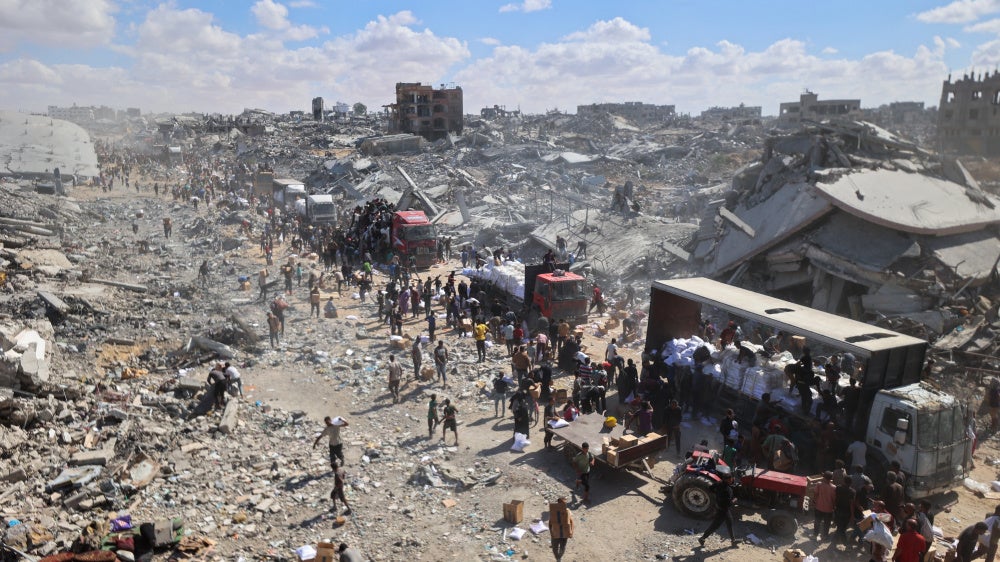 Aid trucks enter the Kerem Abu Salem crossing in Khan Younis, Gaza, October 12, 2025.