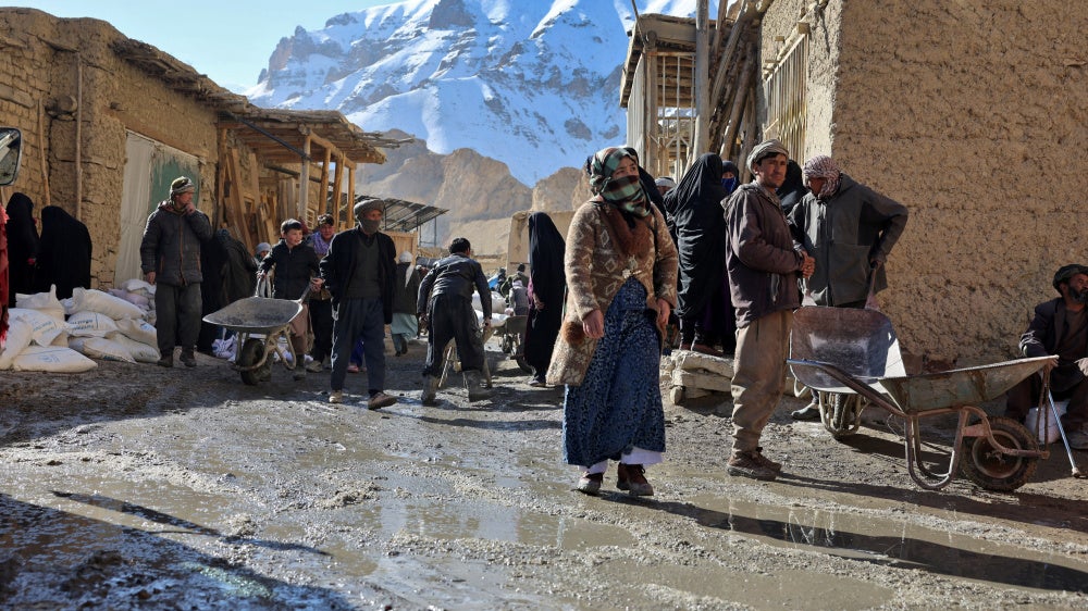 People congregate outside a World Food Programme food distribution center in Yakawlang, Bamyan province, Afghanistan, January 1, 2026. 