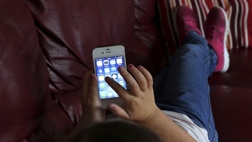 A child using a cellphone.