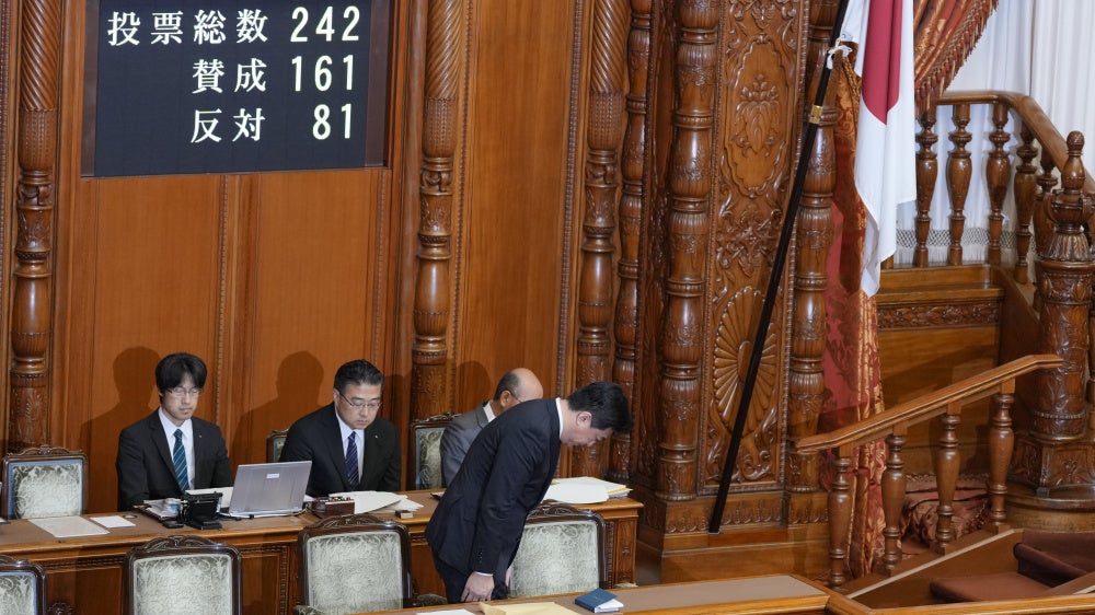 Japan's chief cabinet secretary, Minoru Kihara, bows to members of the House of Councilors after lawmakers passed a law prohibiting desecration of the national flag, Tokyo, July 17, 2026.