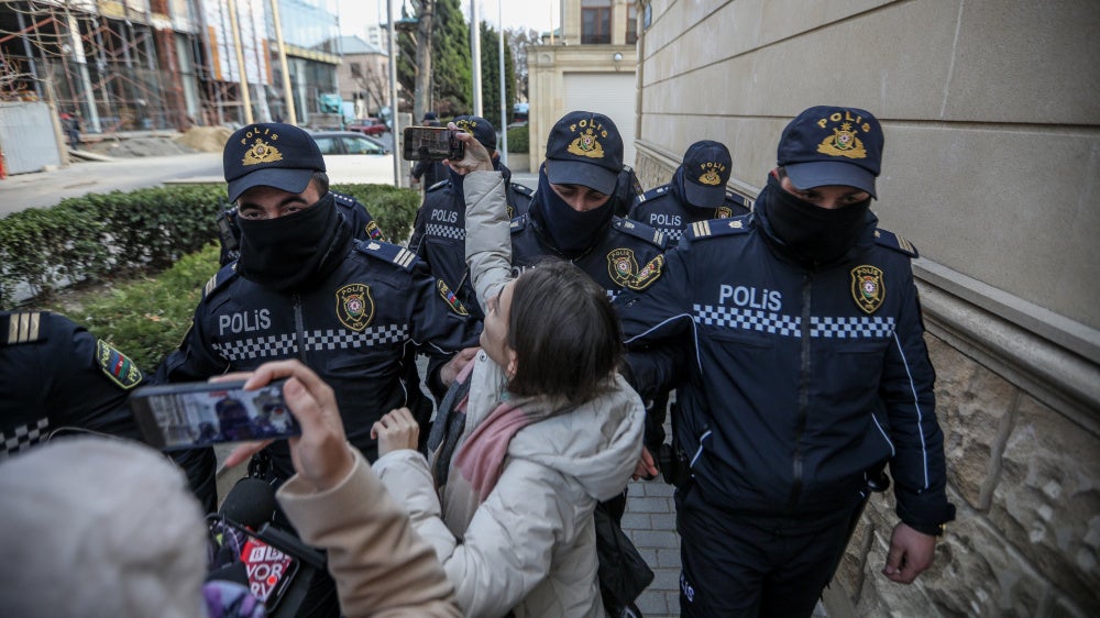 Police removing journalists from Toplum TV on March 6, 2024 in Baku, Azerbaijan.