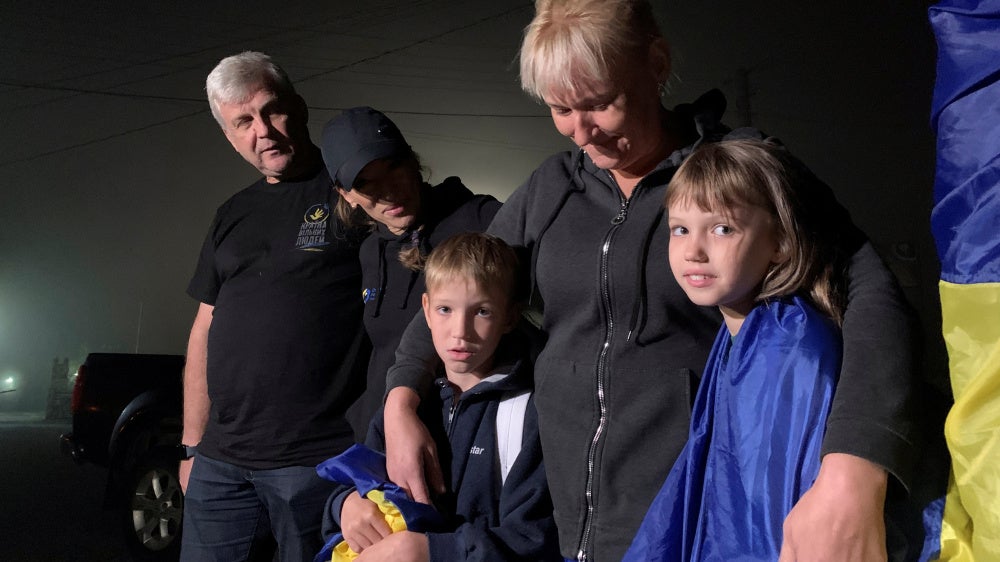 A mother hugs her children after their return from the occupied territory of Ukraine via the Ukraine-Belarus border, amid Russia's attack on Ukraine, in Volyn region, Ukraine, on September 3, 2023.