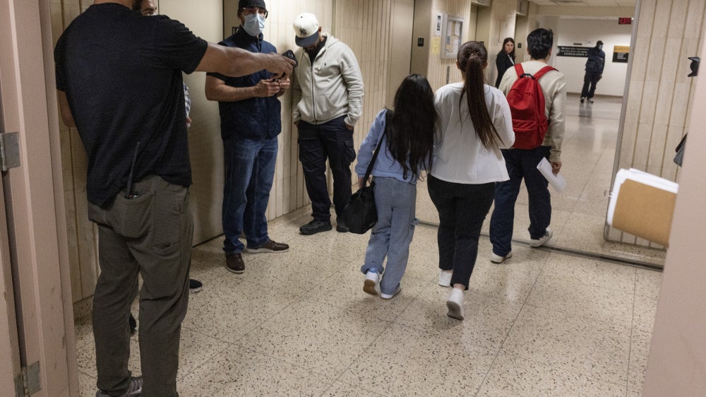 Plainclothes Immigration and Customs Enforcement (ICE) officers detain an immigrant leaving their scheduled court appearance at a Federal immigration court in New York City, June 4, 2025.