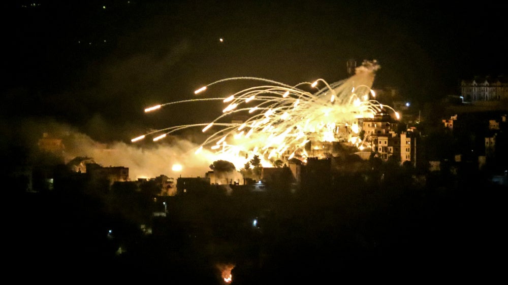 A white phosphorus munition airbursts over buildings in the town of Khiam in southern Lebanon during an Israeli bombardment on October 31, 2024.